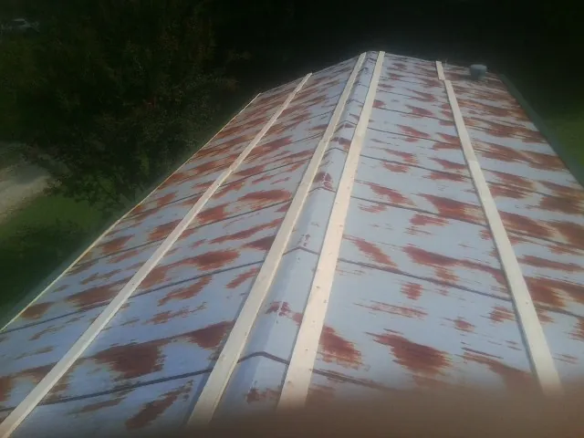 Rusted metal roof panels with new wood purlins before replacement — Storm Damage Roof Repair in Wallingford by Roofing Brothers