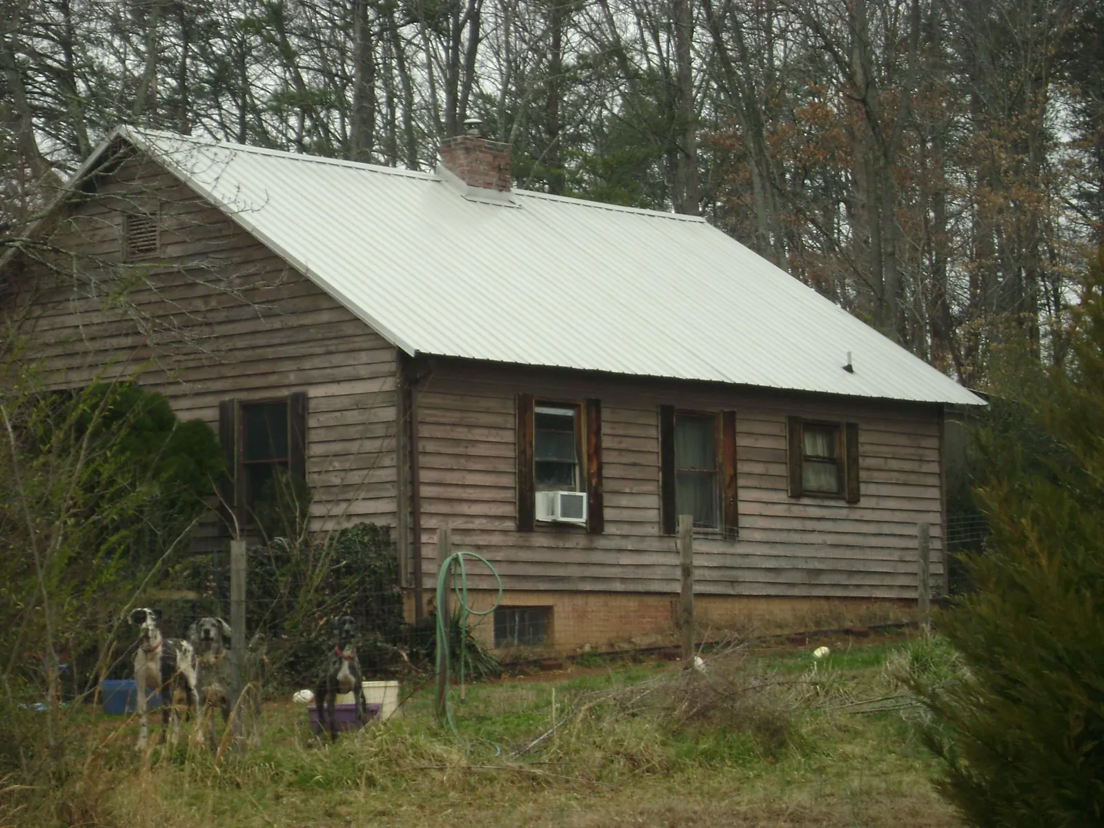 White metal roof on an old wood sided farmhouse, from a Metal Roof Installation job in Wallingford